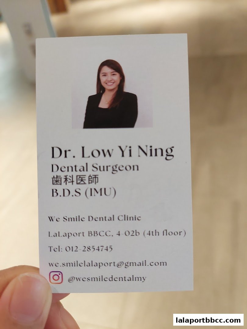 A business card for Dr. Low Yi Ning, a Dental Surgeon at We Smile Dental Clinic.