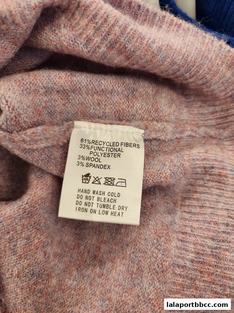 A close-up of a garment's care label showing fabric composition and washing instructions.