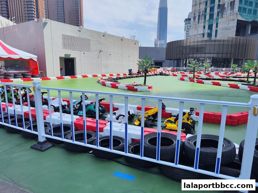 An outdoor go-kart track with several karts lined up and ready for racing.