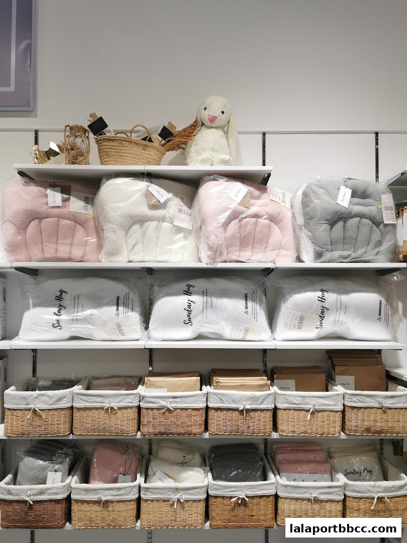 Shelves display various home goods including plush toys, cushions, and storage baskets.