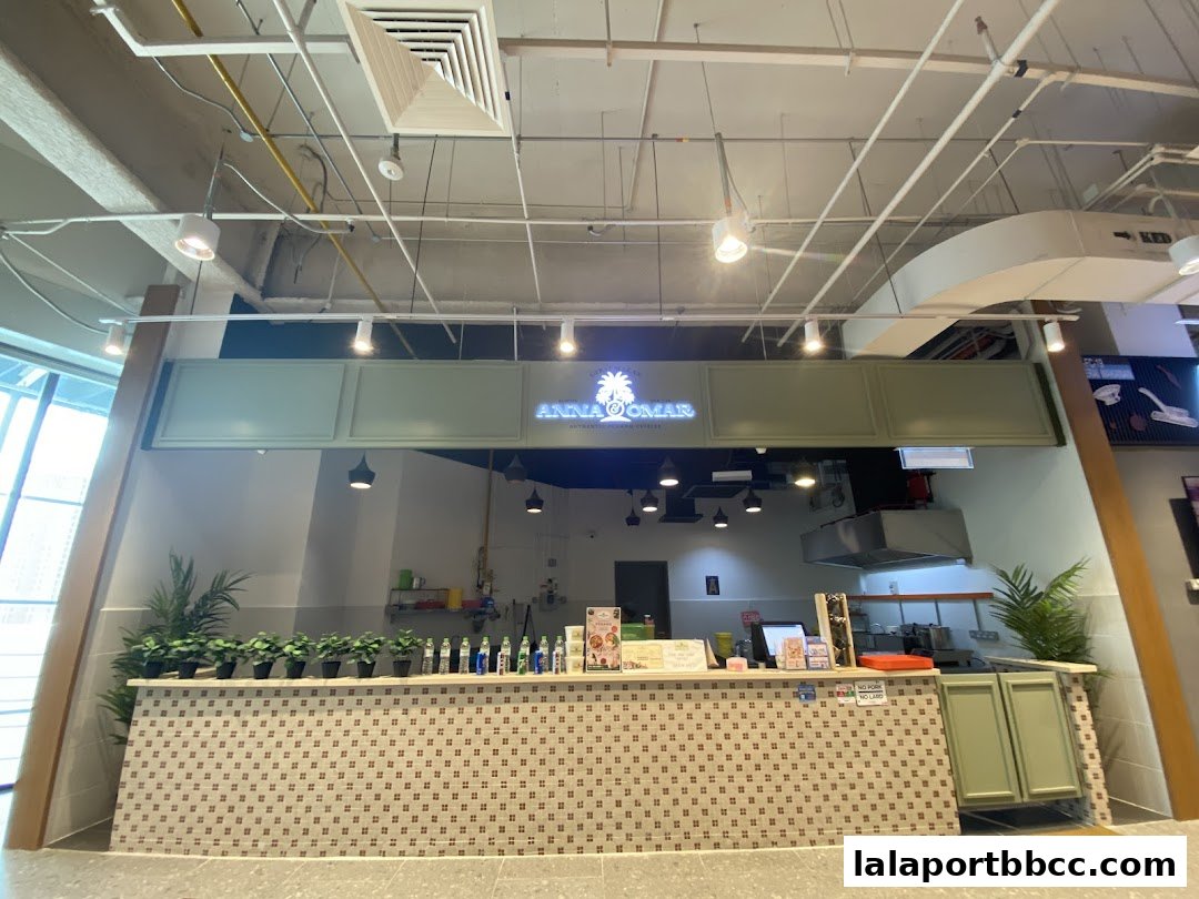 The clean and modern storefront of Auntie Anna Pak Cik Omar, featuring a tiled counter and decorative plants.