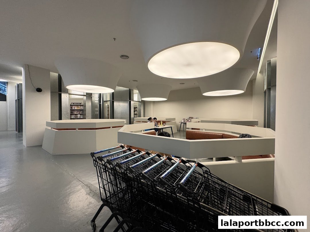 Interior view of BookXcess LaLaport with seating areas and shopping carts.