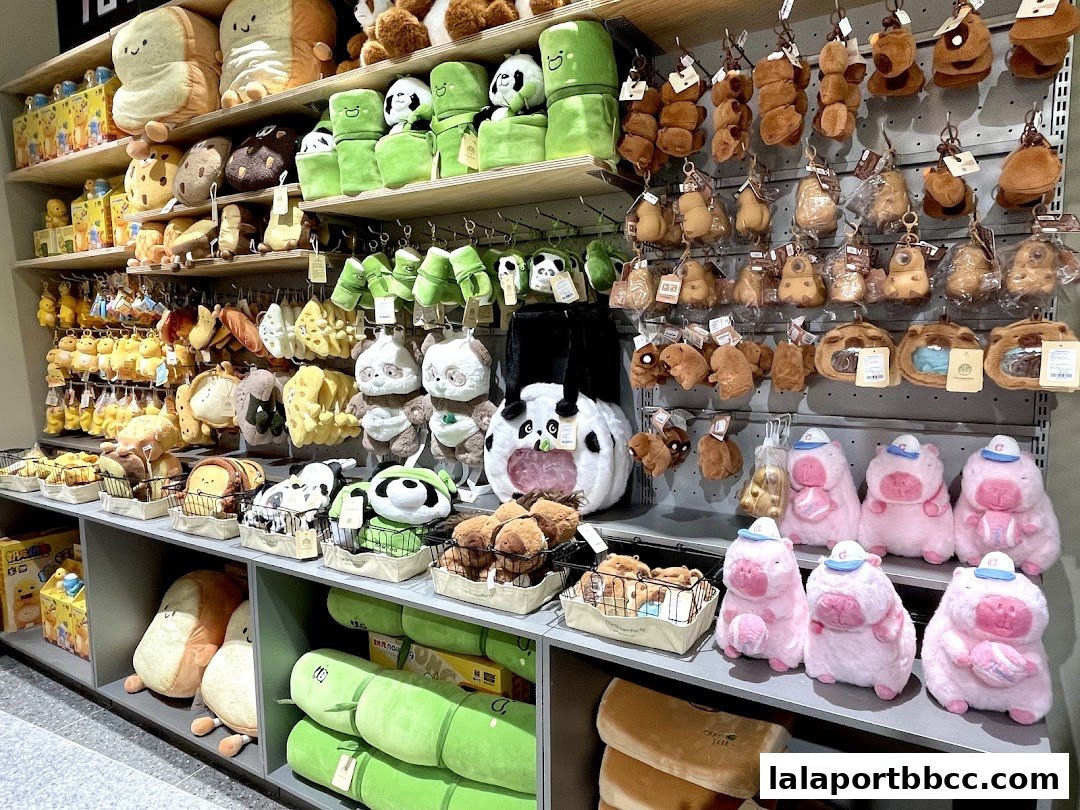 A wide variety of cute plush toys, including food-themed and animal characters, displayed on shelves.