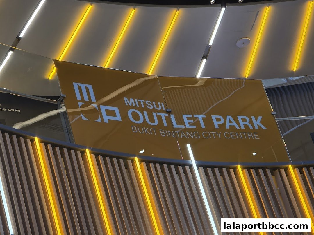 A sign for Mitsui Outlet Park Bukit Bintang City Centre with yellow and white lighting.