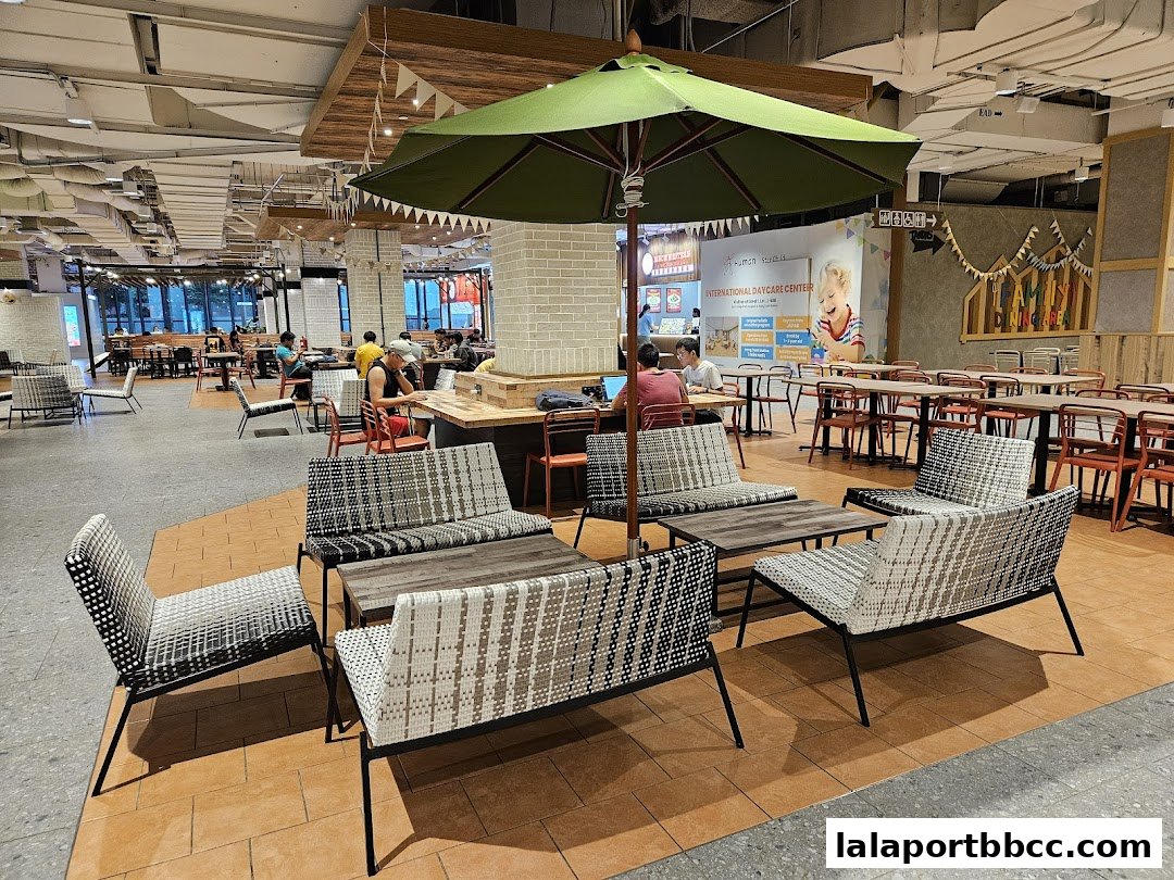 A spacious food court with various seating arrangements and dining tables.