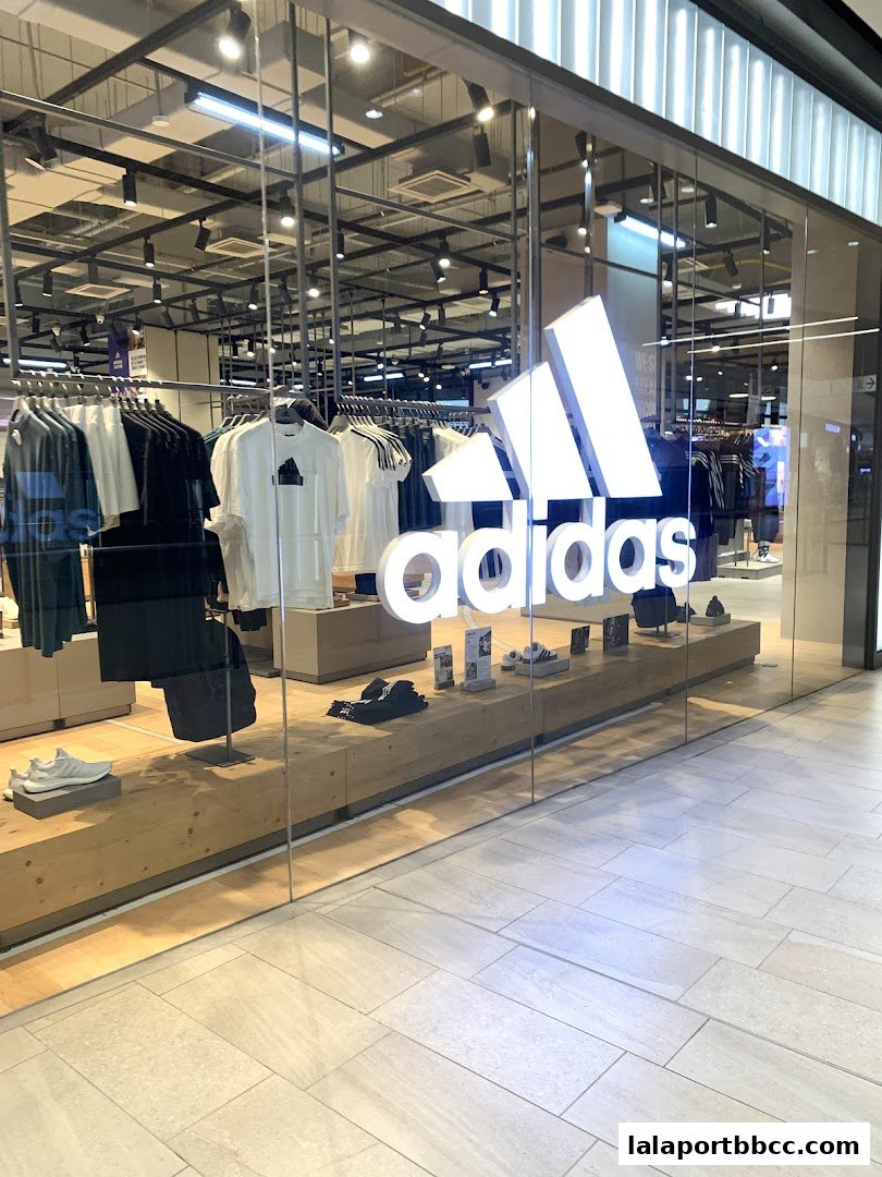 The storefront of an Adidas Originals shop displaying apparel and footwear.