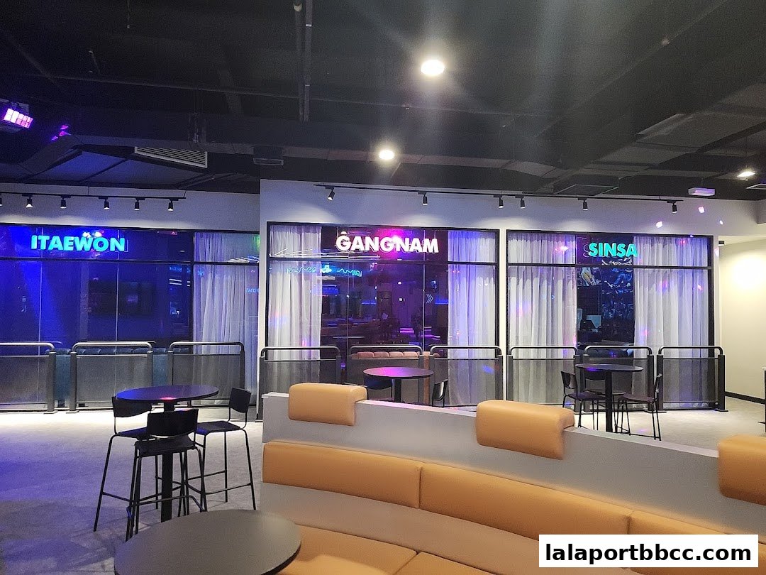 Interior view of a modern entertainment venue with neon signs and seating areas.