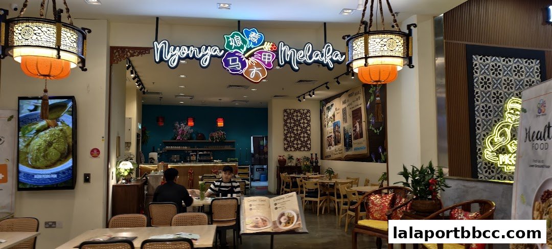 Interior of a restaurant with a neon sign, seating, and decorative elements.