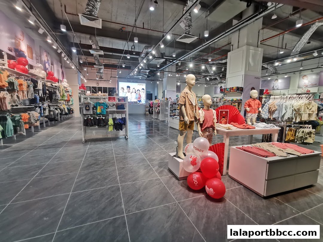 Interior view of a Poney children's clothing store with mannequins and merchandise.