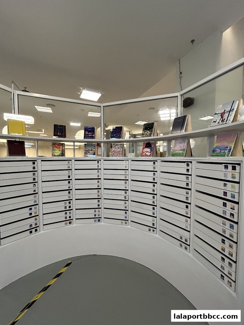 A display of notebooks with various covers and organized drawers in a retail store.