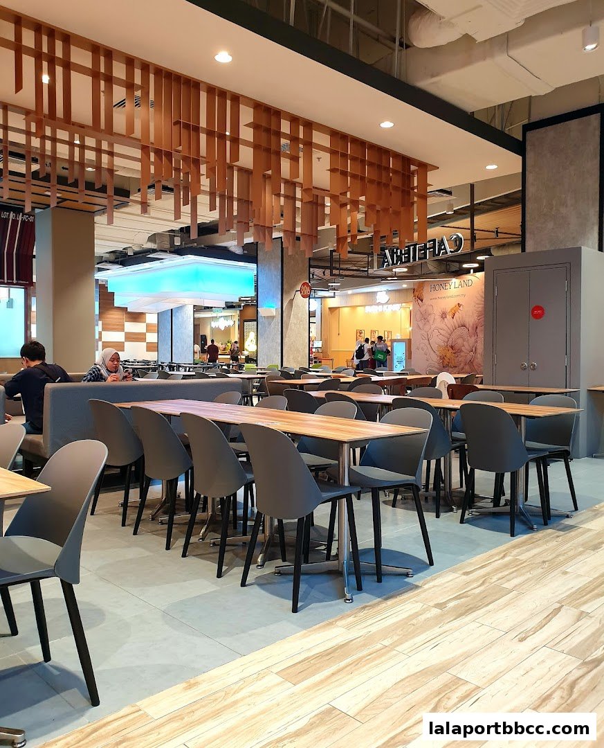 Interior view of a modern cafeteria with tables, chairs, and a decorative wooden ceiling.