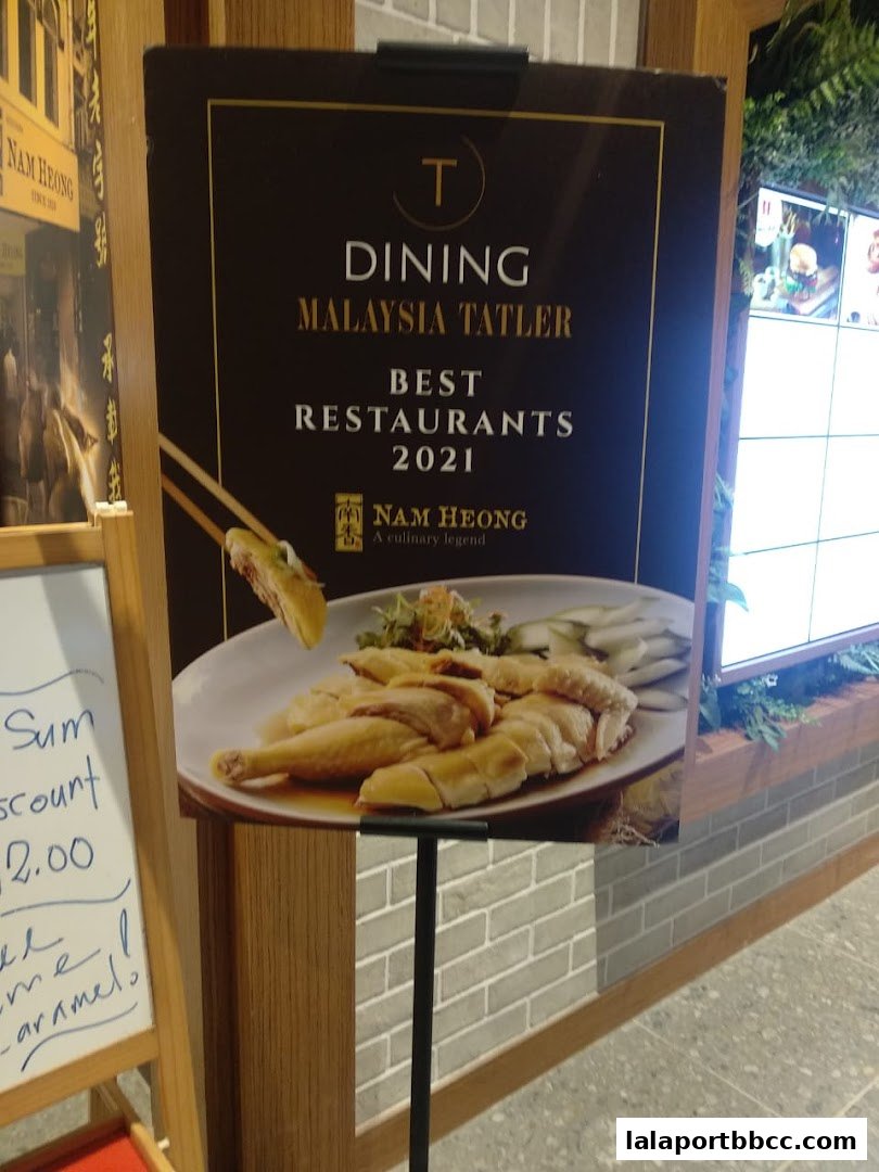 A sign advertising Nam Heong Chicken Rice as a best restaurant in Malaysia Tatler 2021.