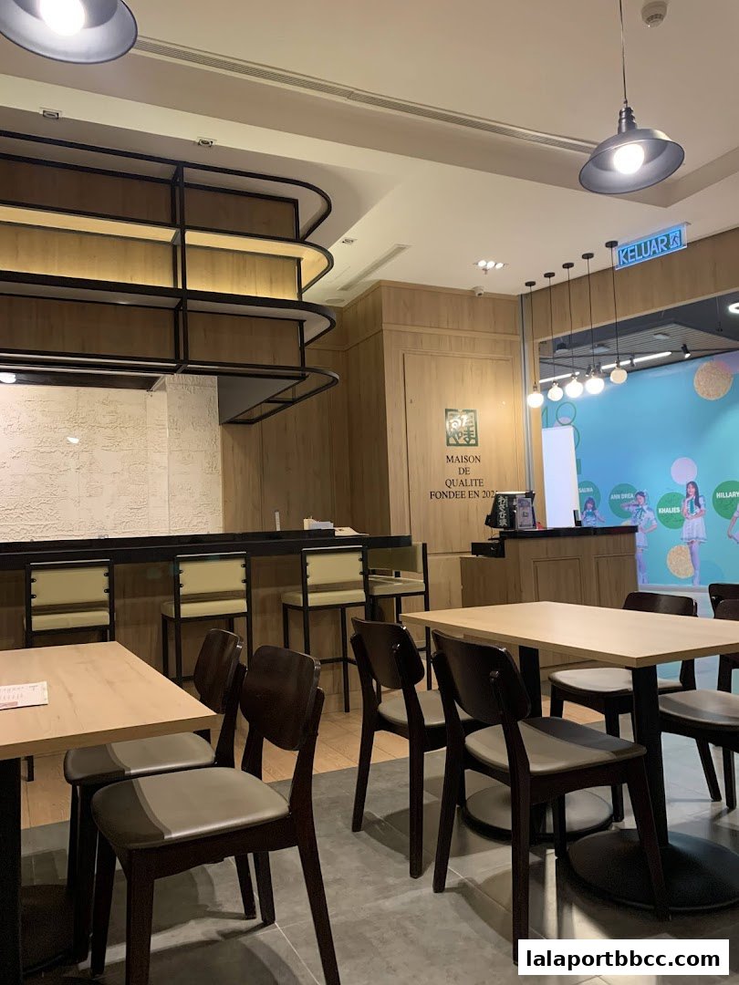 Interior view of a restaurant with tables, chairs, and a counter.
