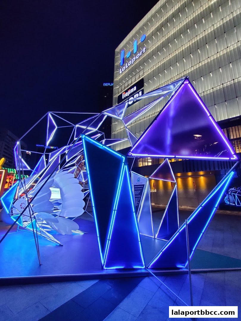 A striking geometric art installation with blue and purple neon lights outside Lalaport BBCC.