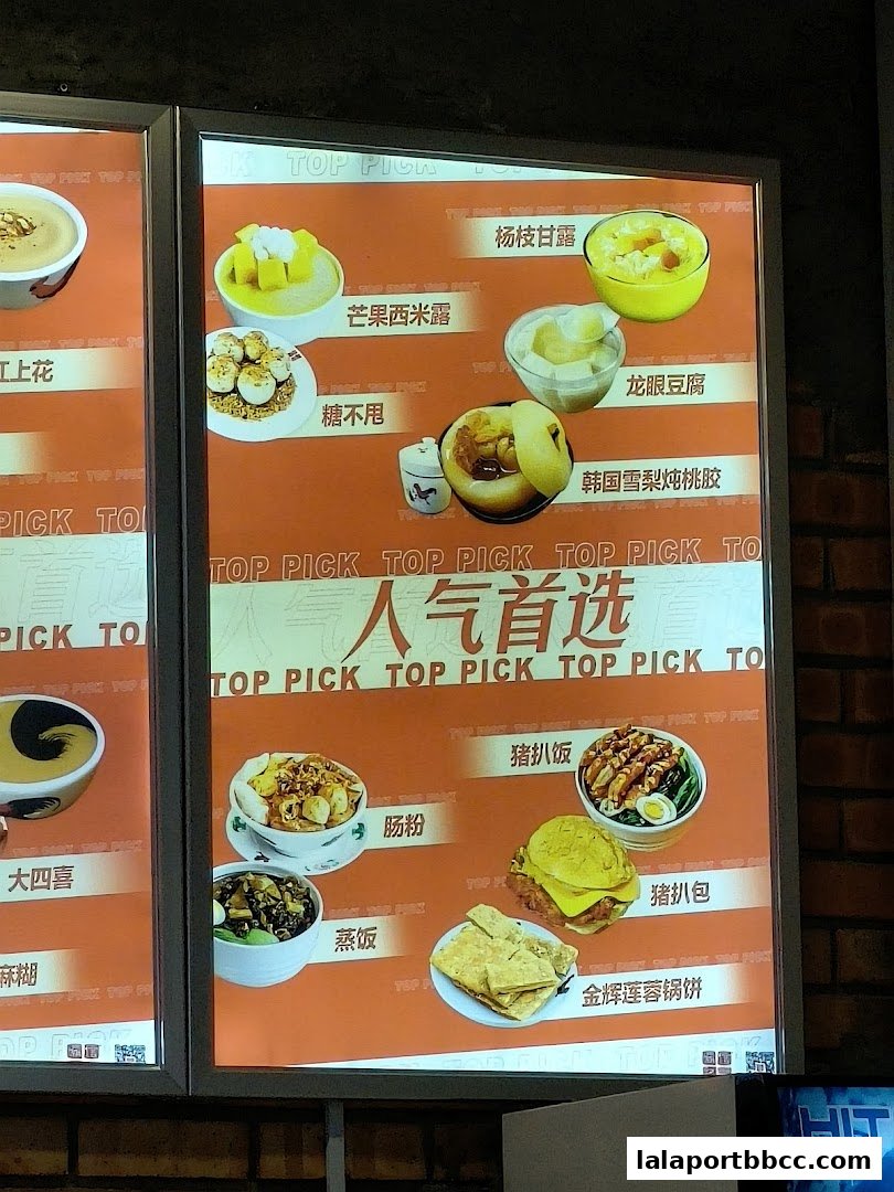A brightly lit menu board showcasing various popular dessert and food items with appealing visuals.