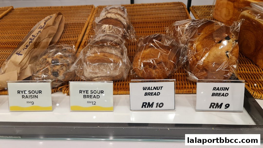 A display of freshly baked breads, including rye sour raisin, walnut, and raisin bread.
