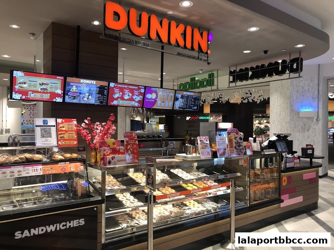A Dunkin' Donuts shop with a display of donuts, sandwiches, and beverages.