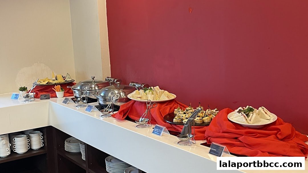 A buffet spread featuring sandwiches, canapés, and cheese platters on a counter.