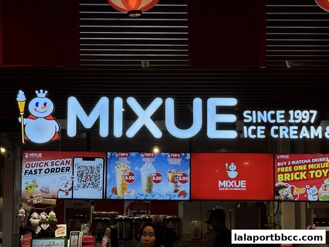 The MIXUE ice cream and tea shop front with illuminated signage and product displays.