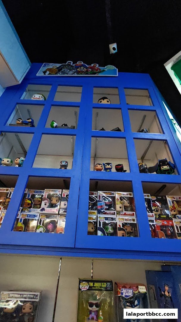 A blue display cabinet filled with various collectible figures and boxed toys.