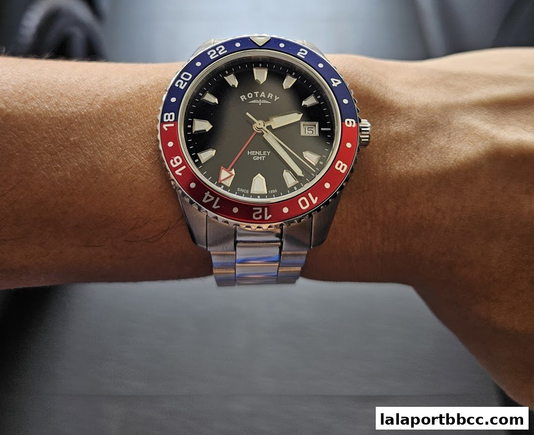 A close-up shot of a Rotary Henley GMT watch worn on a person's wrist.