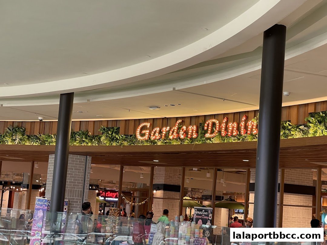 A sign for 'Garden Dining' with illuminated letters above a restaurant.