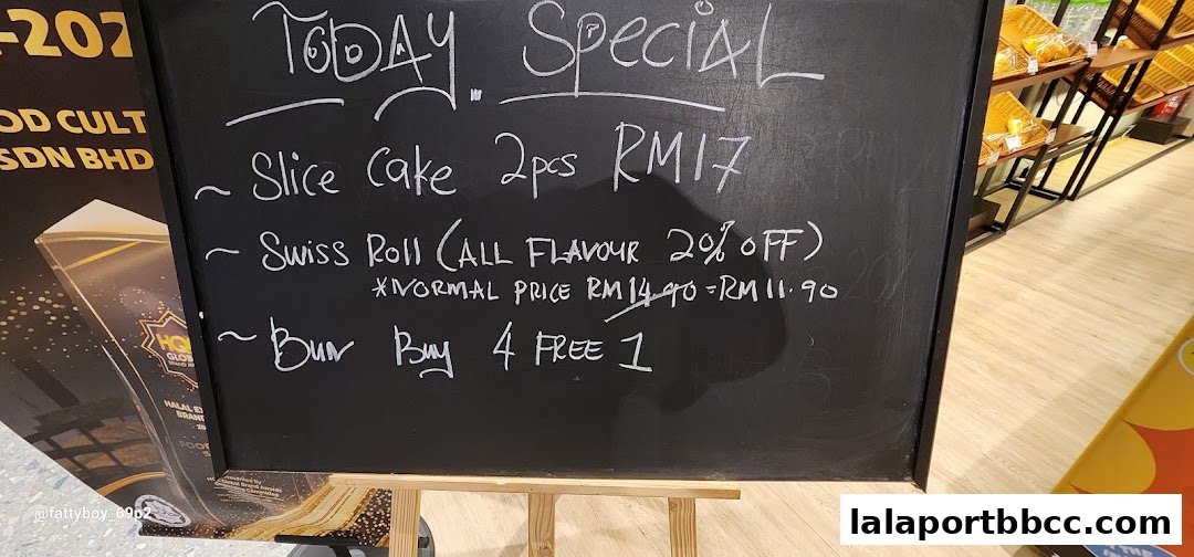 A chalkboard displaying today's specials for a food court, featuring deals on cake, swiss rolls, and buns.