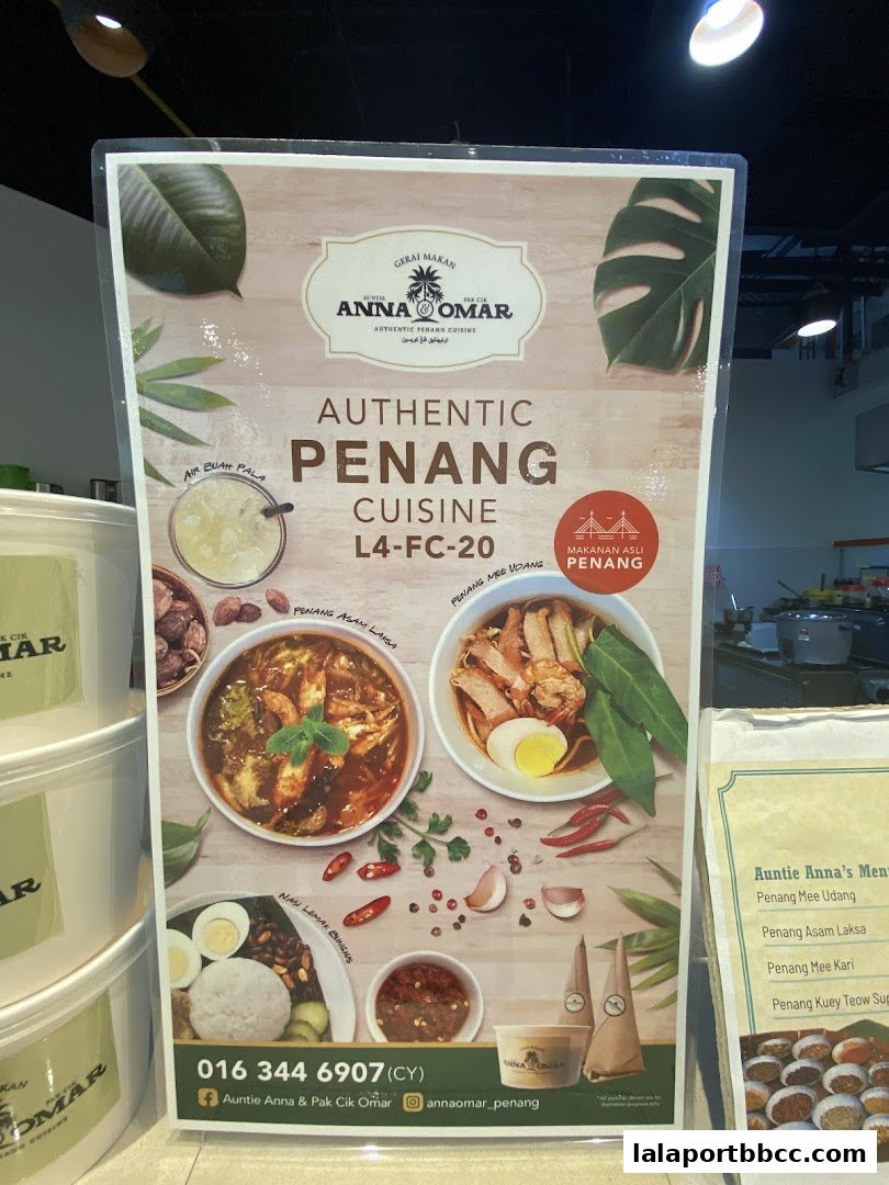 A menu board showcasing authentic Penang cuisine with images of popular dishes.