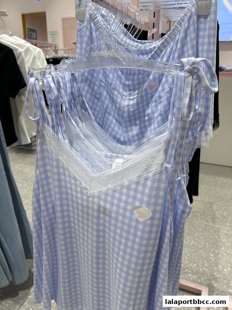 Close-up of light blue and white checkered pajamas with lace trim.