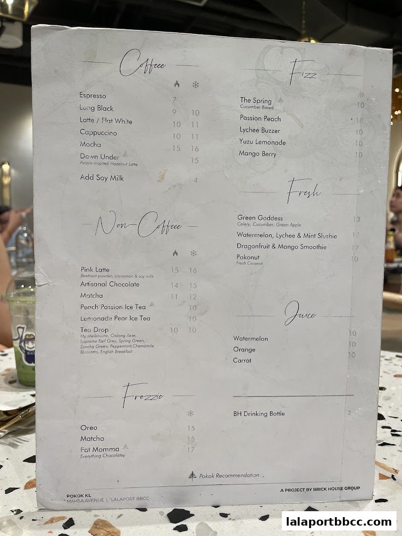 A menu from POKOK LaLaport featuring coffee, non-coffee drinks, fizzes, fresh juices, and frozzies.