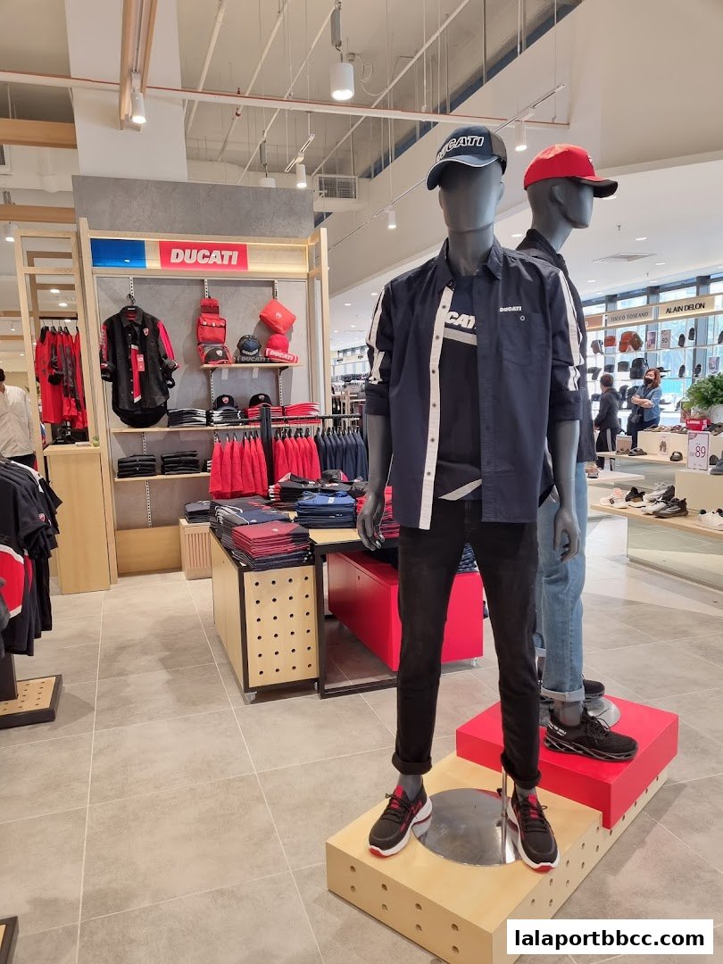 Mannequins wearing Ducati apparel and accessories in a retail store.