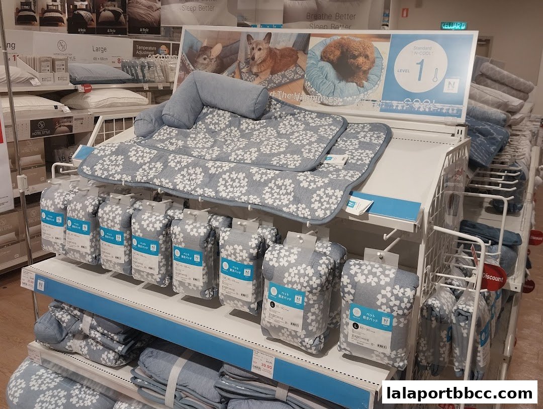 Display of pet cooling mats and bedding with floral patterns in a retail store.