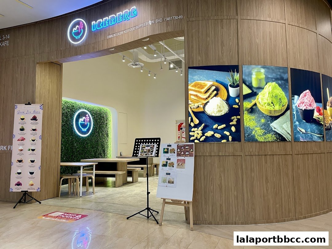 The entrance of Iceberg LaLaport, a dessert cafe with vibrant food displays and a modern interior.