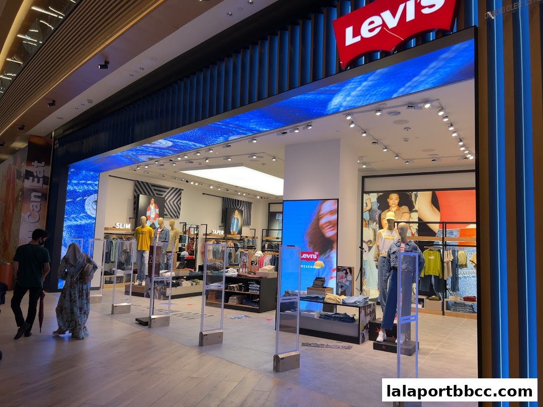The entrance of a Levis store with mannequins displaying clothing and the Levis logo.