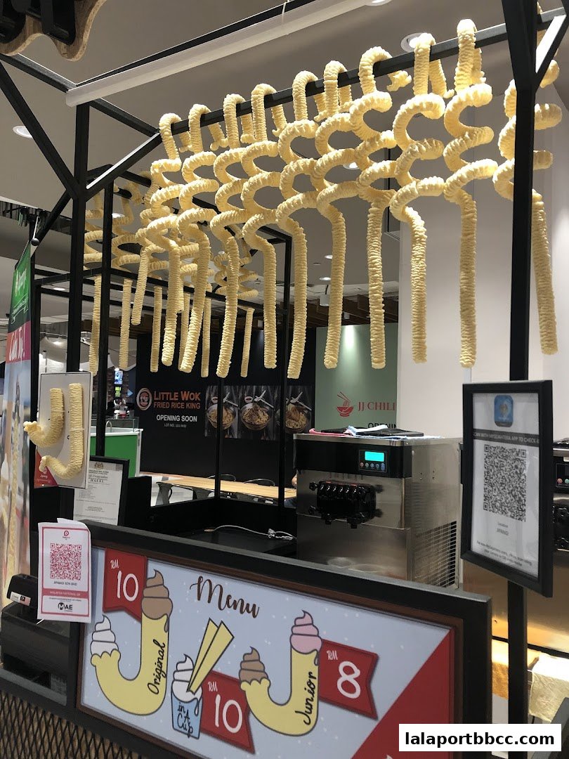A food stall with a unique hanging noodle decoration and a menu featuring ice cream.