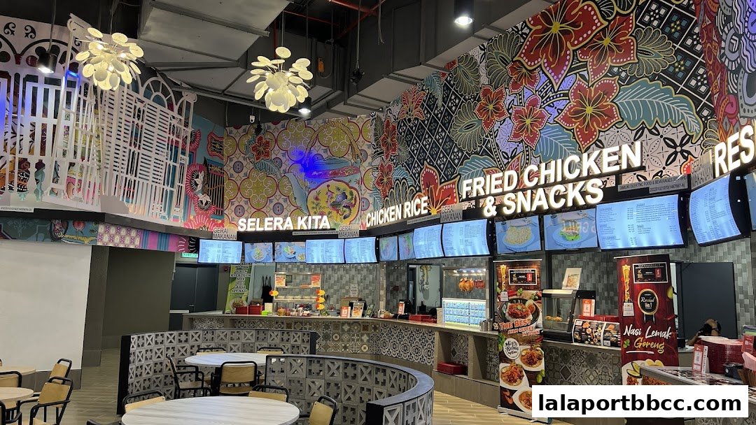 A vibrant food court with colorful murals, seating areas, and digital menu boards.