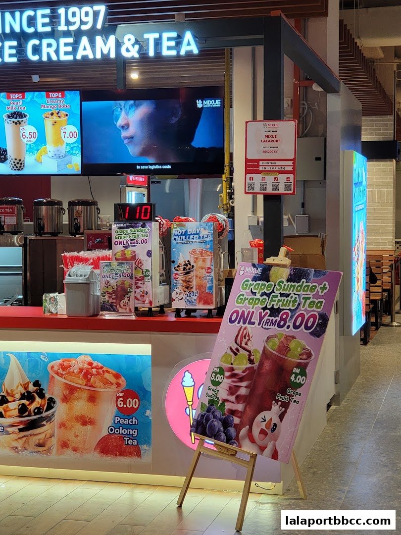 A MIXUE ice cream and tea shop with promotional posters and a digital display.