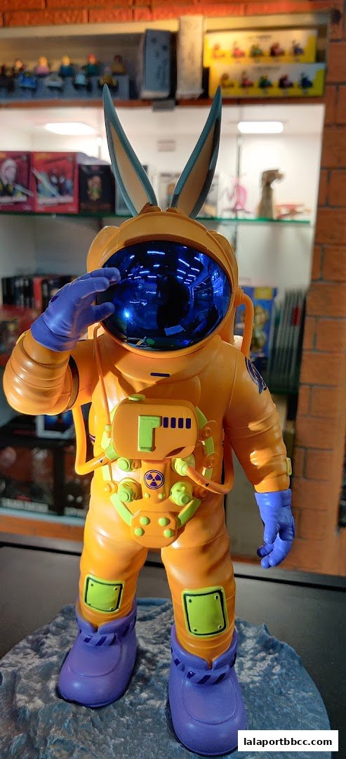 A detailed figurine of a character in an orange astronaut suit with bunny ears.