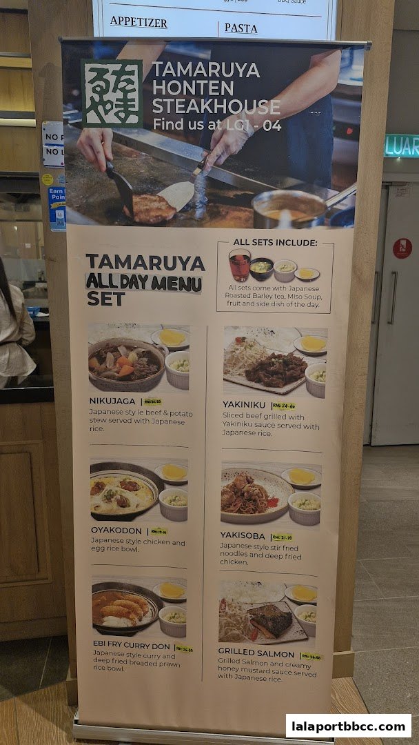 A menu display for Tamaruya Honten Steakhouse featuring various Japanese set meals.