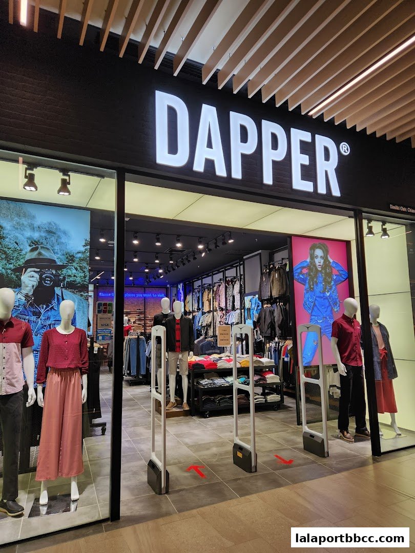 The entrance of Dapper, a clothing store, showcasing mannequins and apparel inside.