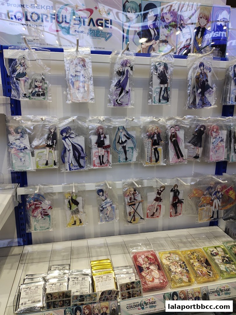 Animate shop displaying various anime character merchandise, including acrylic stands and cards.