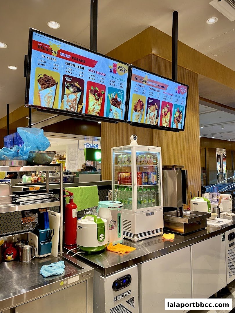 Digital menu boards displaying various beef and chicken kebabs with prices.