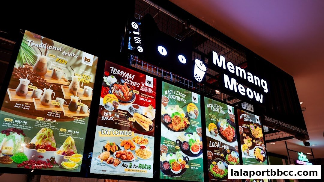 A brightly lit menu board showcasing various Malaysian dishes and drinks at Memang Meow.