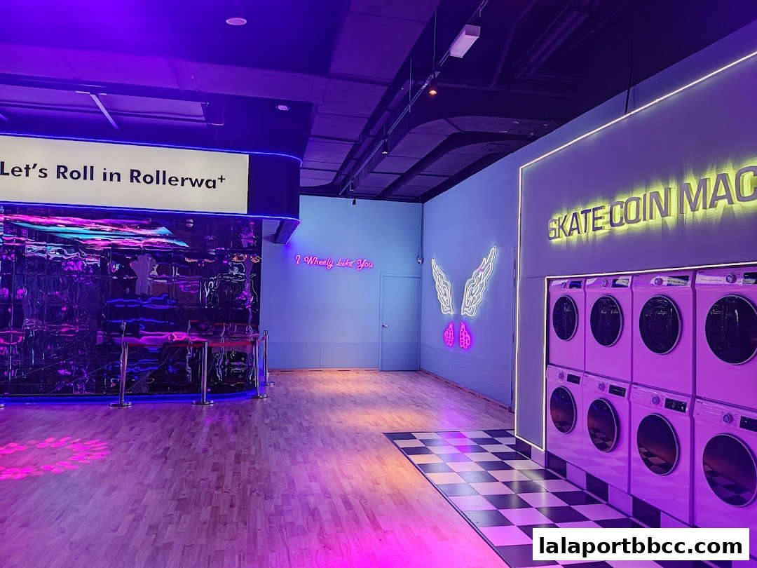 Interior of Rollerwa Kuala Lumpur with neon signs, roller skates, and washing machines.