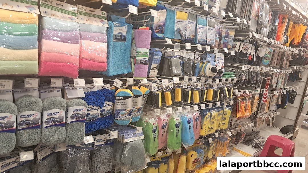 A wide selection of car cleaning supplies, including microfiber cloths, sponges, and wash mitts, neatly displayed on shelves.