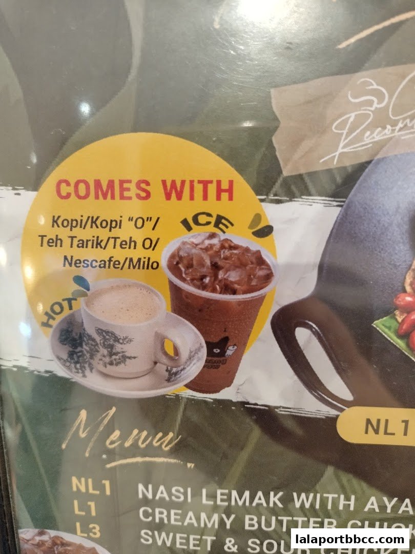 A close-up of a menu featuring Malaysian dishes and drinks, with images of coffee and iced beverages.