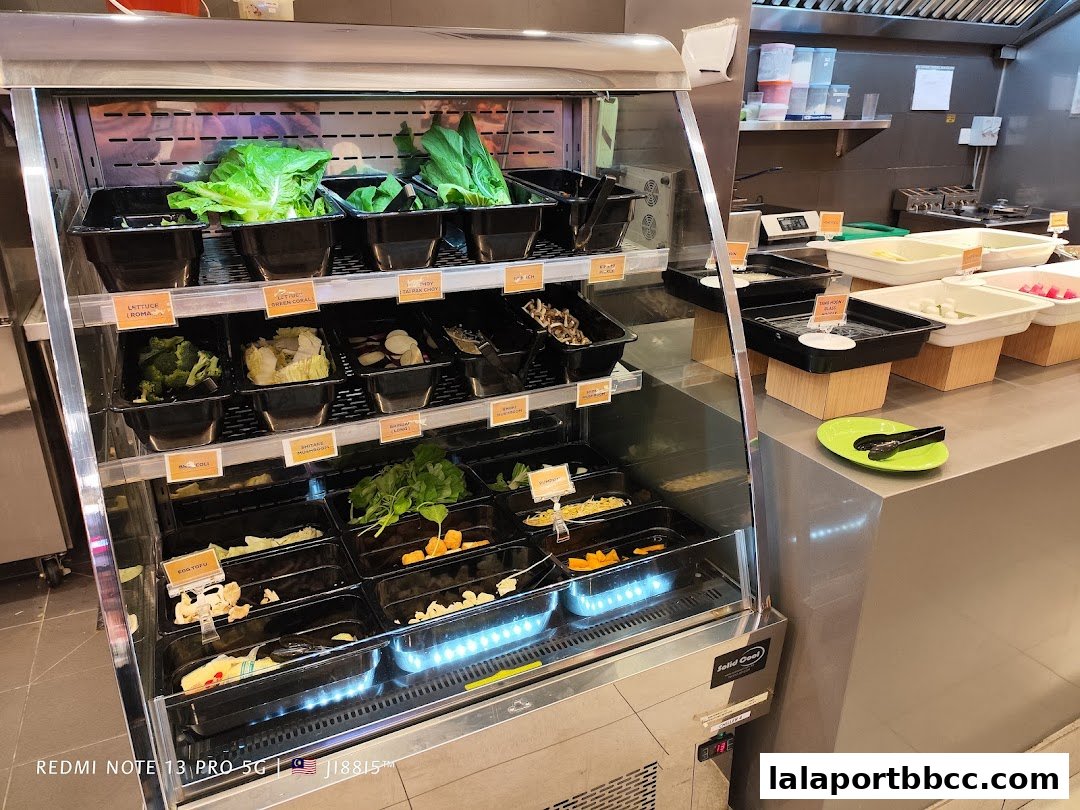 A display cooler filled with fresh ingredients for hot pot or similar dishes.