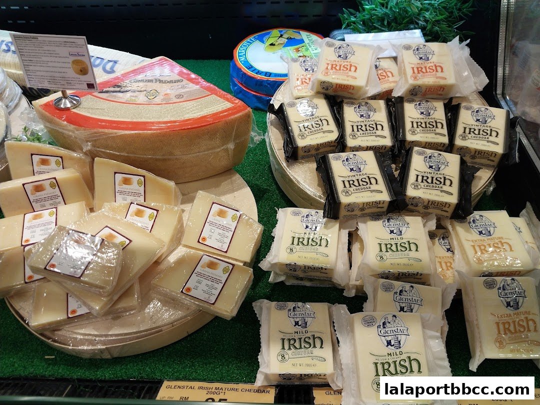 A display of various cheeses, including Grana Padano and Glenstar Irish Cheddar.