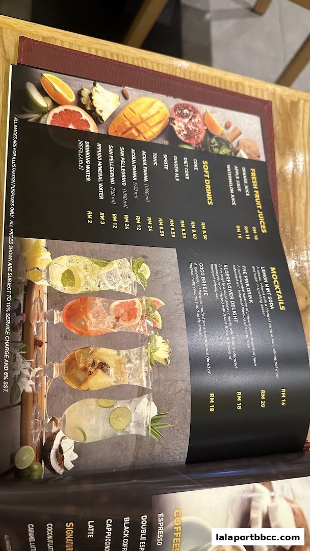 A menu featuring refreshing mocktails, fresh fruit juices, and soft drinks with vibrant imagery.