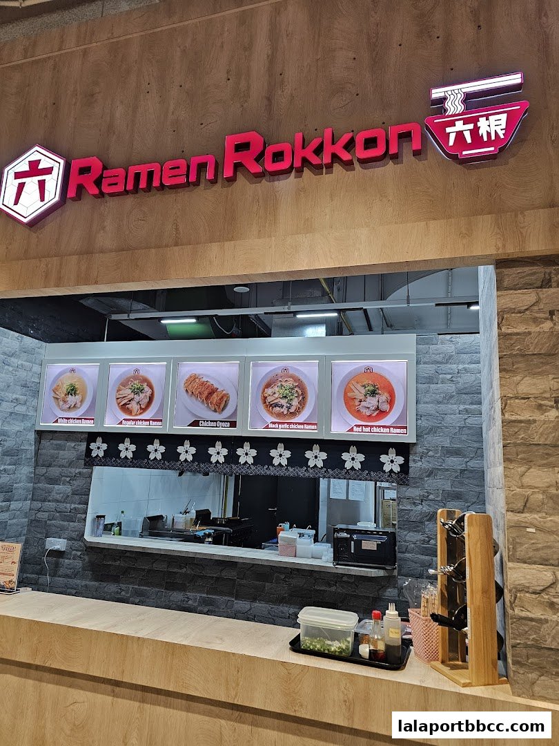 The entrance of Ramen Rokkon, a Japanese noodle shop, with a menu display.